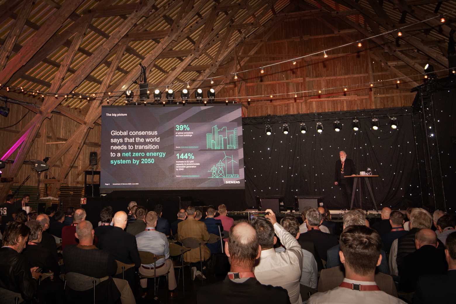 Image from Wirepas OPEN event, Klaus Weather from Siemens on stage, giving a presentation about building automation and next-gen autonomous buildings