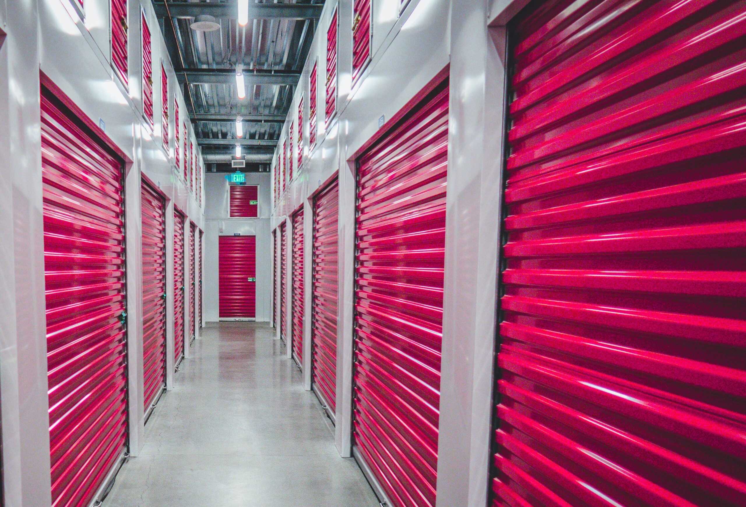 Image of a row of red self storages with shutter doors