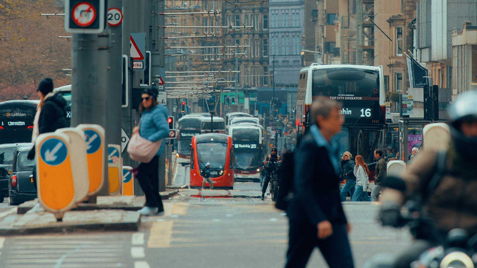 modern city with electric vehicles sharing the road with people walking
