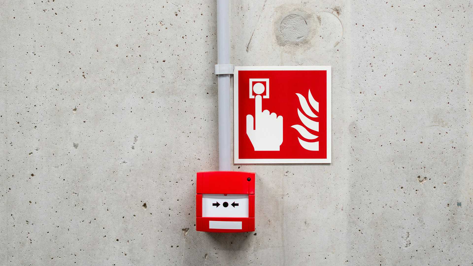 fire alarm mounted on a cement wall