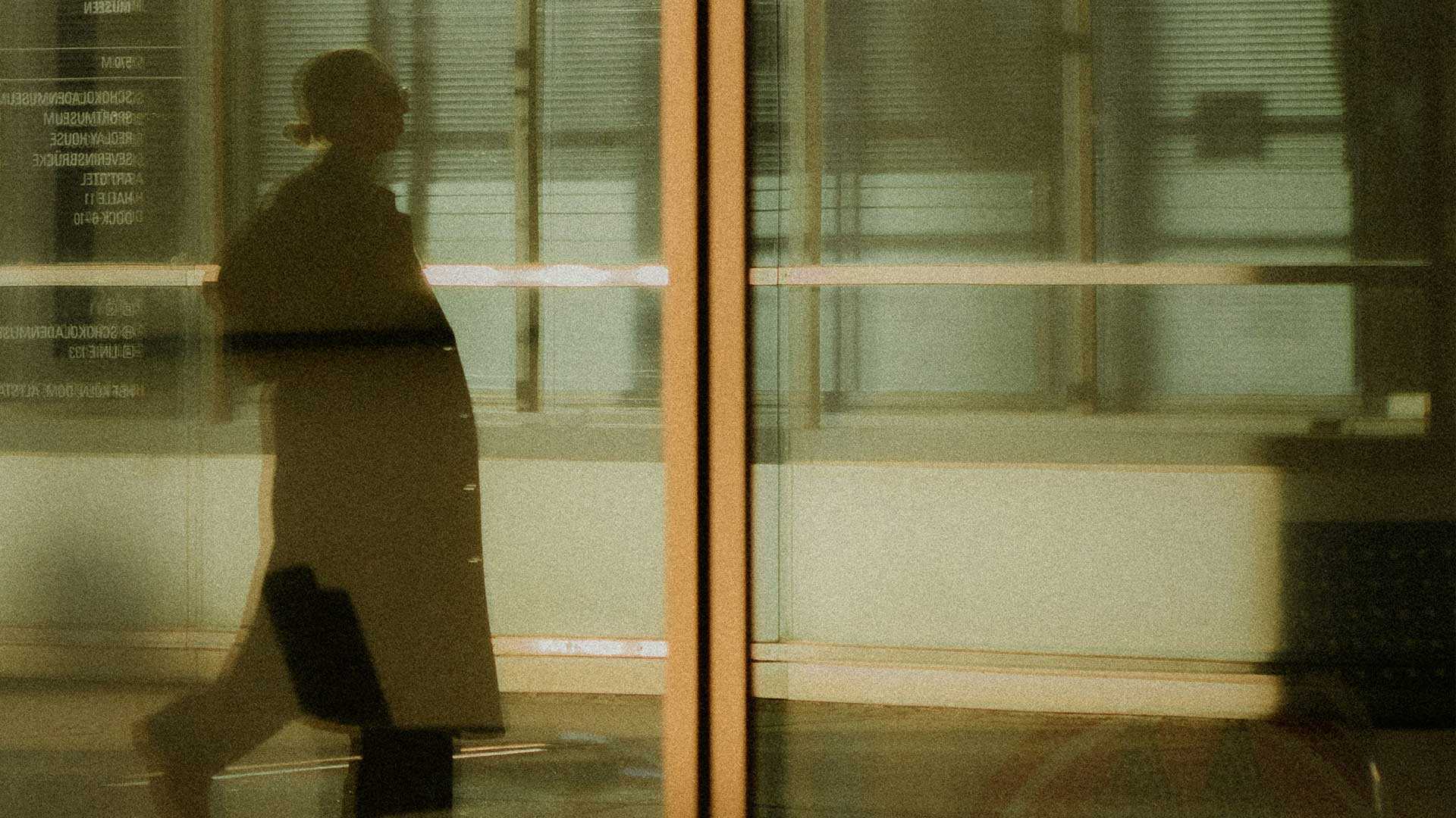 Person walking by a glass sliding door