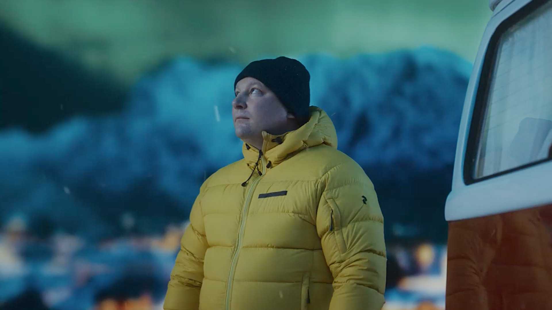 Image of a man wearing a yellow down jacket in a wintery environment